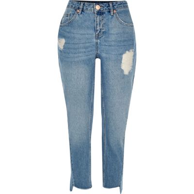 Mid blue wash ripped twisted seam jeans